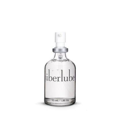 Clear spray bottle labeled 'uberlube' on a white background